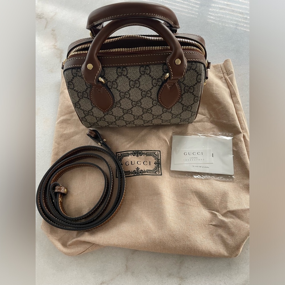 Gucci mini top handle bag. Like new- perfect condition. 
Dust bag included